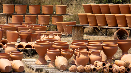 Huge clay jugs in the sun . Clay products trade