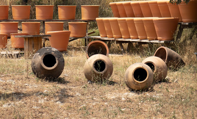 Huge clay jugs in the sun . Clay products trade