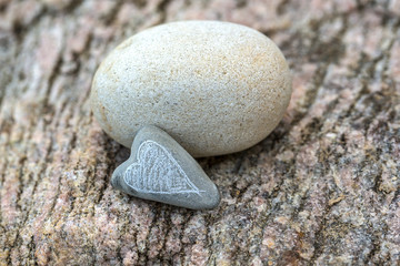 Fototapeta na wymiar Pebble With Heart On A Rock