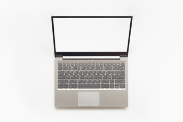 Top view of Open modern laptop with English keyboard and copy space blank screen, isolated on white background.