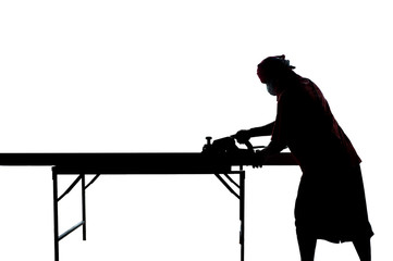 Isolated silhouette portrait of carpenter scrubs the wood with electrical tool at the construction...