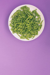 Asparagus beans on a white plate.