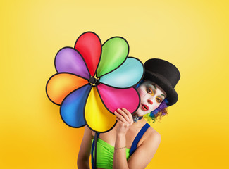 Clown with colored helix on yellow background