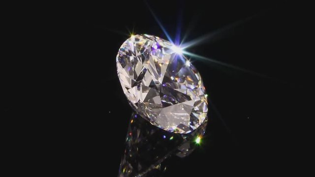 View of a beautiful sparkling 10 carat diamond, close-up on a black background.