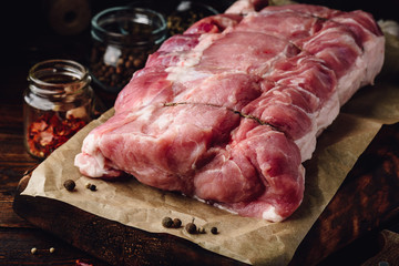 Raw pork loin joint on cutting board