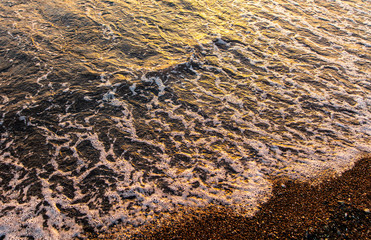 Waves on the seashore at sunset