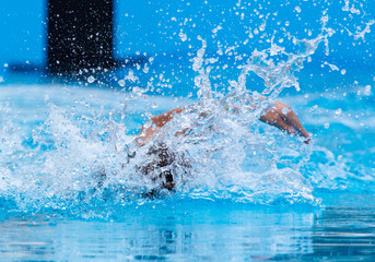 A man is swimming in the pool