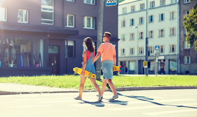 summer, relations, traffic, extreme sport and people concept - happy teenage couple with short...