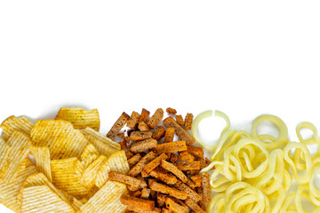 Assortment of Unhealthy Snacks: chips, onion rings, crackers top view, flat lay. Unhealthy eating concept.