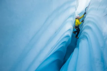  Ice climbing between canyon walls covered in wavy lines carved by meltwater. © DCrane Photography