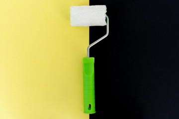 Painting roller on colorful background. Preparation for repair