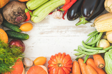 Healthy food background with autumnal vegetables and fruits. Autumn fruits vegetables and leaves. Thanksgiving day concept. Top view. Copy space