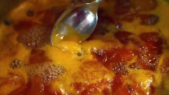 Slow motion 4k - Housewife Takes Foam From apricot Jam with spoon