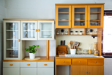Front view of a kitchen interior with furniture and kitchen tools at home