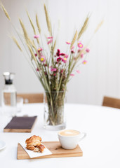 A cup of cappuccino on the table in a Scandinavian-style cafe.