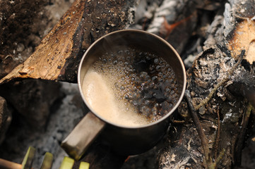 Aromatic and hot coffee on campfire
