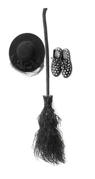 black halloween witch's broom and witch hat on a white background