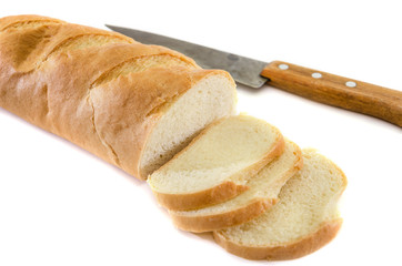 loaf and knife isolated on a white background. Delicious Ukrainian bread. Sliced slices of bread.