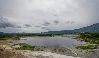 Panorama of hot springs, boiling mud pools and warm toxic lakes in Uzon caldera. Kronotsky Nature Reserve in Russian far east, Kamchatka peninsula. Protected environment . Access by helicopter only.