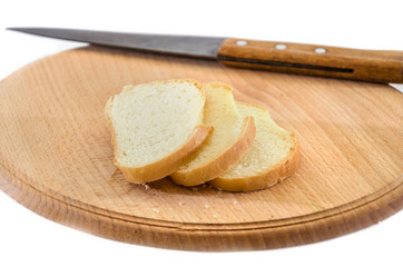 long loaf on a wooden board and knife isolated on a white background. Tasty Ukrainian bread