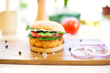 Delicious fast food. Homemade hamburger. Large. Homemade, beef hamburger with cheese and vegetables.
