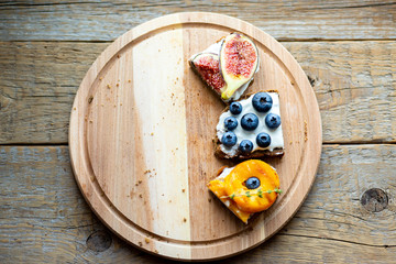 Fototapeta na wymiar Bruschetta with berries Board Healthy breakfast Vegetarian food