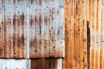 Texture of rusty corrugated iron metal sheet texture. Picture with grain and color from film simulation filter.