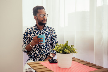 african-american friends drinking coffee on the balcony