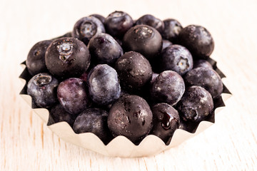 Healthy food concept: frozen blueberries on white background