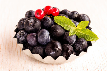 Healthy food concept: frozen blueberries on white background