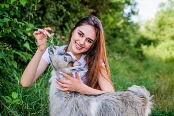 Woman and small goat green grass. Village animals. Girl play cute goat. Feeding animal. Protect animals. Veterinarian occupation. Eco farm. Love and care. Animals law. Farm and farming concept