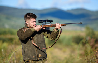 Hunter hold rifle. Focus and concentration of experienced hunter. Hunting and trapping seasons. Hunting permit. Man brutal gamekeeper nature background. Bearded hunter spend leisure hunting