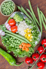 A set of vegetables with rice for a healthy diet: corn, peas, asparagus, carrots, broccoli, lettuce