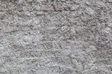 Close-up of a   gray stone wall of a very old building  Gray texture background