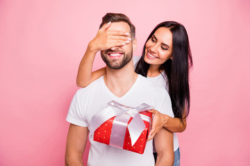 Photo of nice cute couple wearing white t-shirt of young people with girlfriend holding red package with bow congratulating his beloved one happy birthday while isolated with pink background