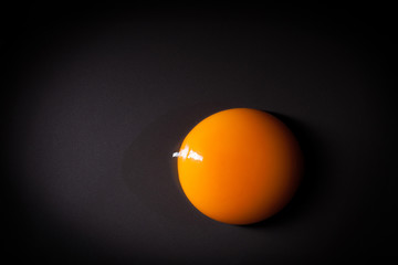 Egg yolk isolated on black background with space for copy - obrazy, fototapety, plakaty