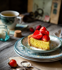 Slice of homemade delicious strawberry tart or pie with sweet glazed berries on top