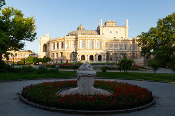 Obraz premium Ukraine, Odessa, 13th of June 2019. Side view of the national academic opera building and the park with the sculpture fountain youth during a sunny day