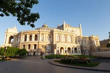 Deurstickers Ukraine, Odessa, 13th of June 2019. Side view of the national academic opera building and the park with beautiful flower beds during a sunny day © Andreas