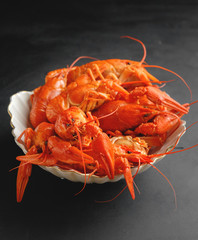 lobsters in a plate on black background