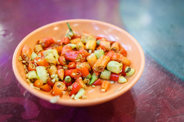 A Plate of Chopped Chilli Padi on a Table