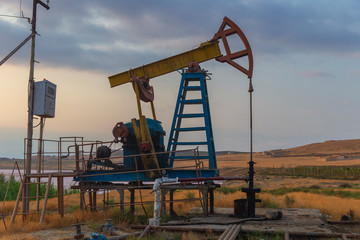 Oil rocking at sunset