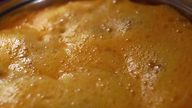 4k Slow motion - mixing apricot jam with plastic spoon  in metal bowl