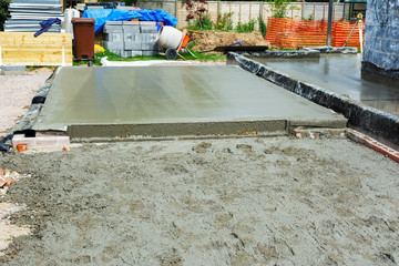 Renovation projects. Building of extension of the existing house, freshly poured concrete foundations, selective focus