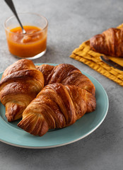 Delicious breakfast with fresh croissants and jam served with butter.