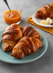 Delicious breakfast with fresh croissants and jam served with butter.