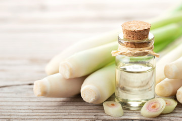 lemongrass essential oil and fresh lemongrass on the wooden table