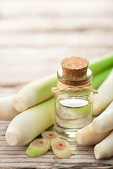 lemongrass essential oil and fresh lemongrass on the wooden table