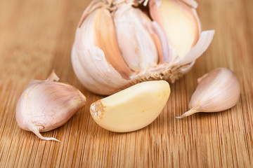 Macro shot. Cloves of garlic on a wooden background.