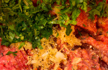 minced beef meat with herbs close-up